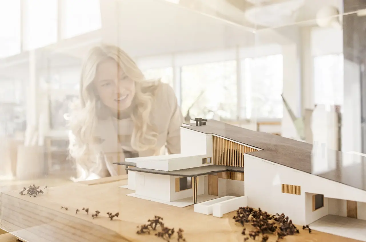 aalto_ateljee woman looks at a house model in Aalto's studio