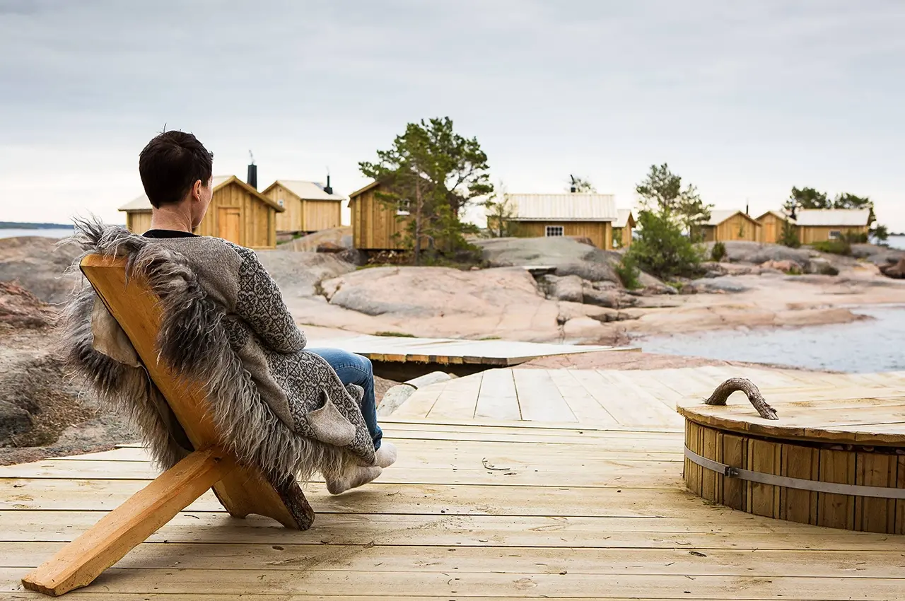 Finland_Klobben man sitting on a wooden deck at Clobber in Finland