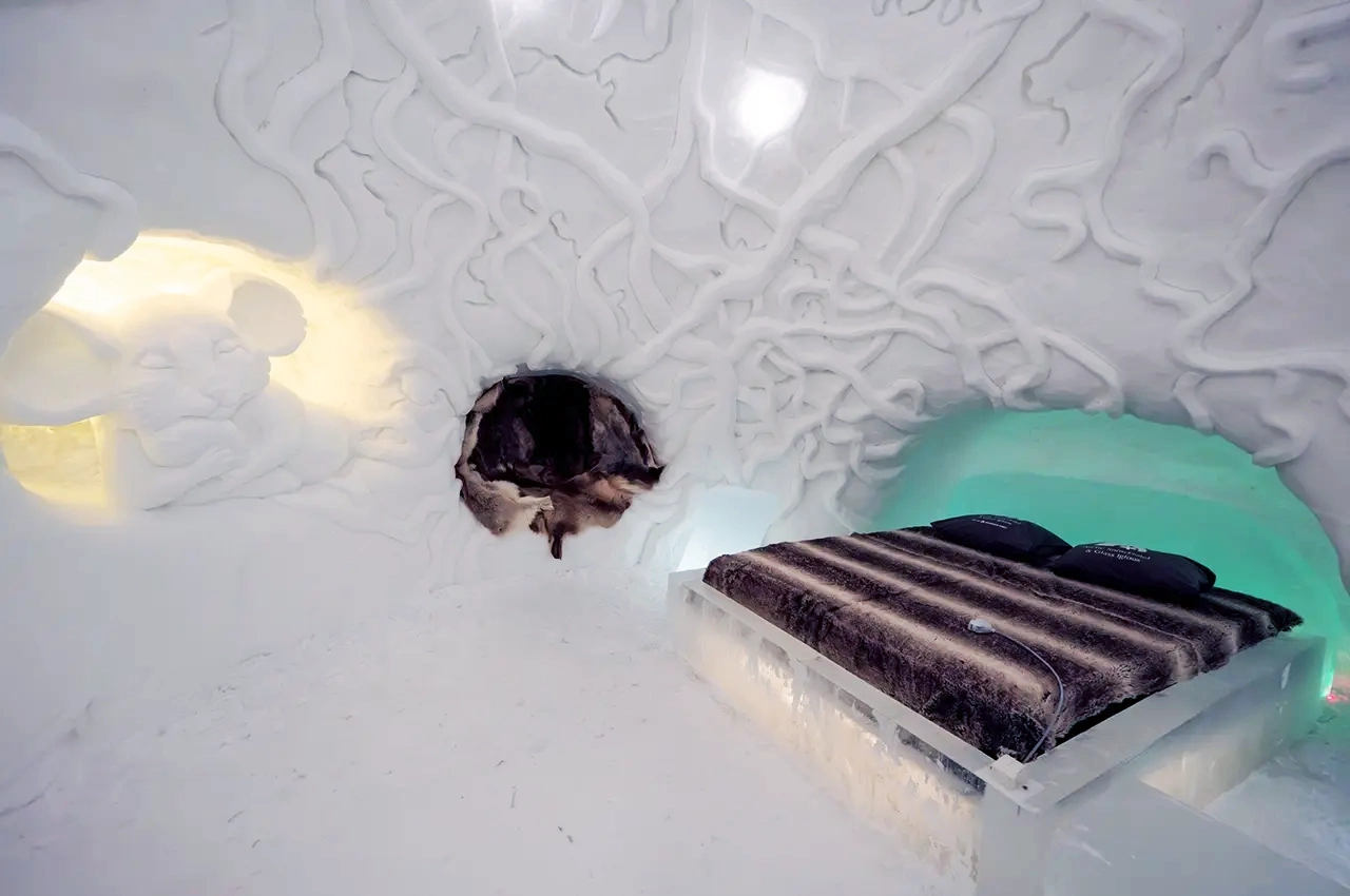 a room at the ice hotel with ice sculptures