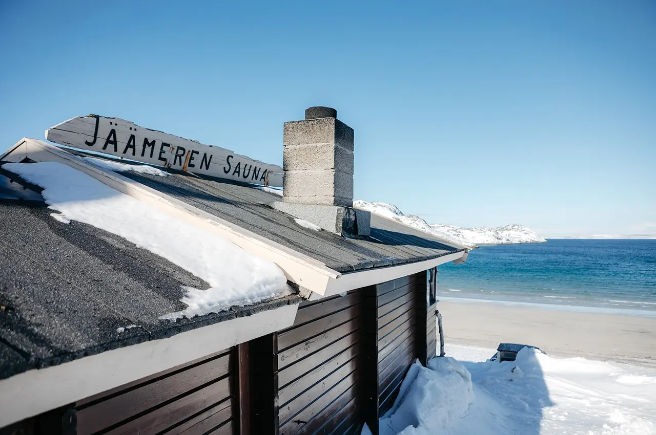 winter sauna, crystal clear lake and mountains. photo: Lapland North